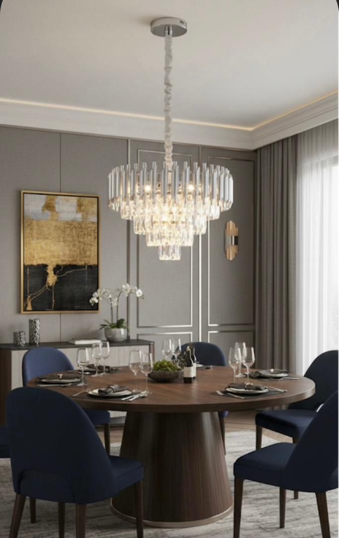 Tall crystal chandelier over a round dining table