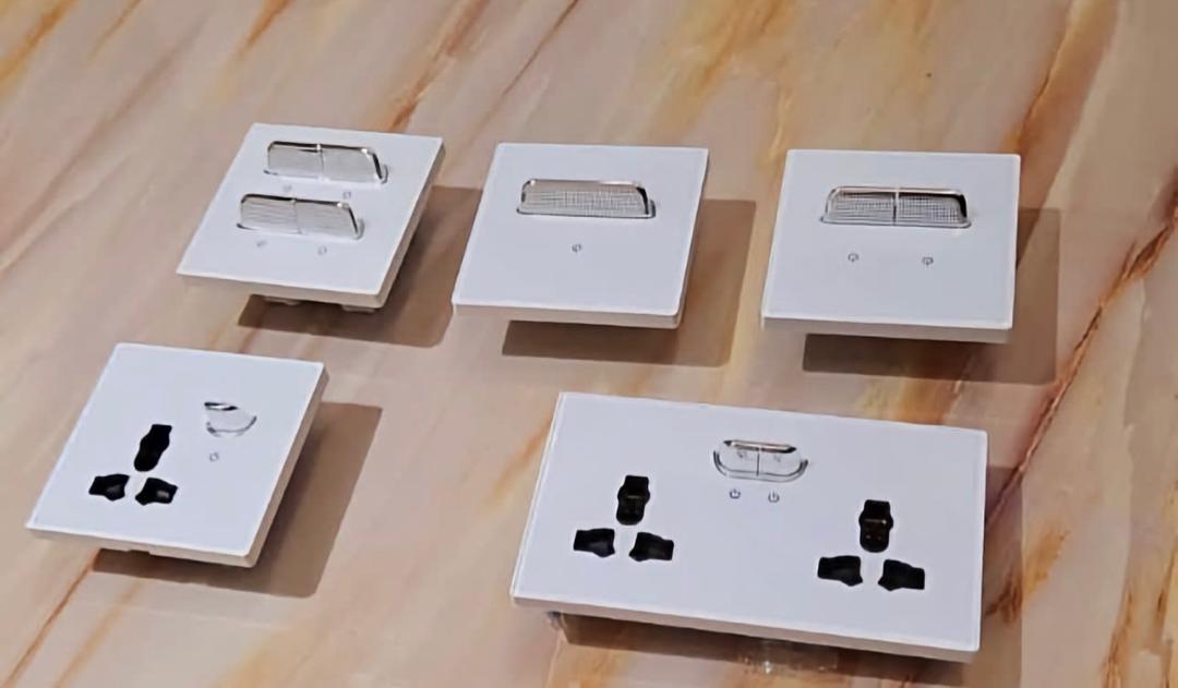 Modern white wall switches and sockets on a marble surface