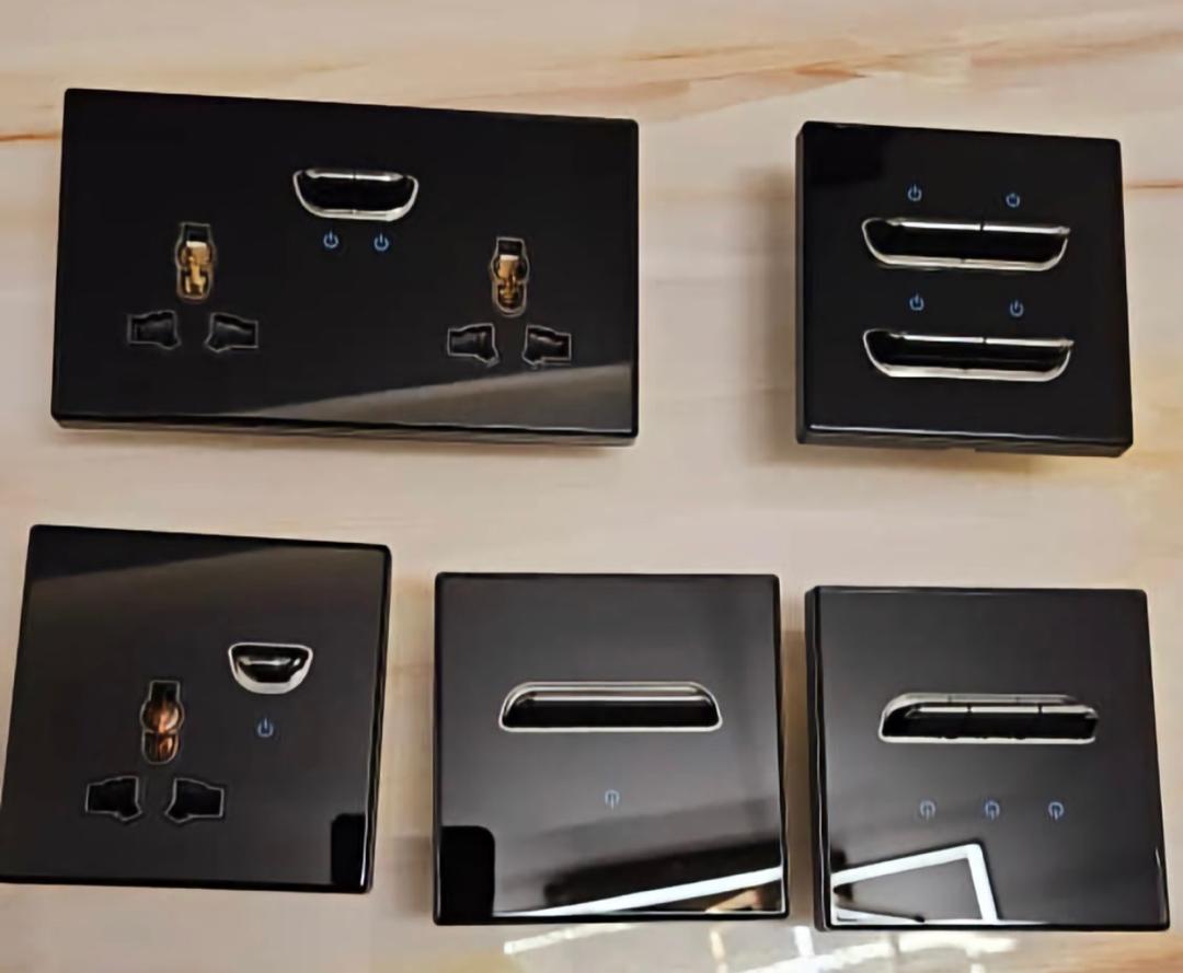 Modern black wall switches and sockets on a marble surface